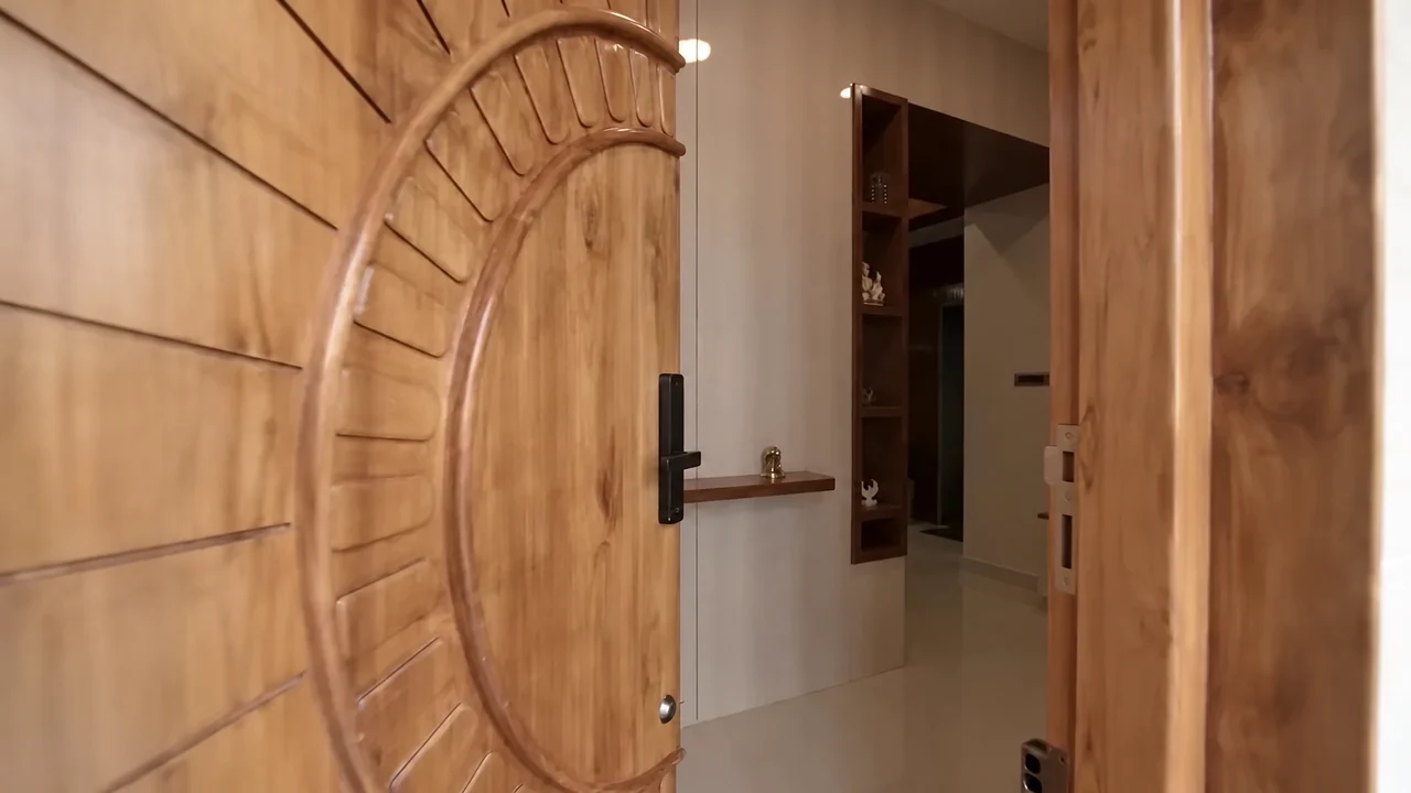 A carved timber front door opening into the home