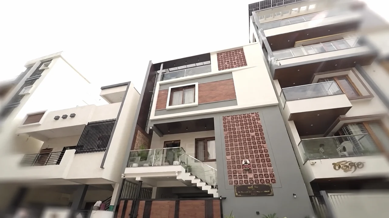 The complete front elevation with balconies, entrance stairs and a brick screen