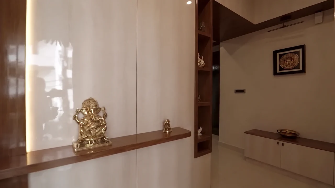 A foyer with recessed display shelves and built-in storage