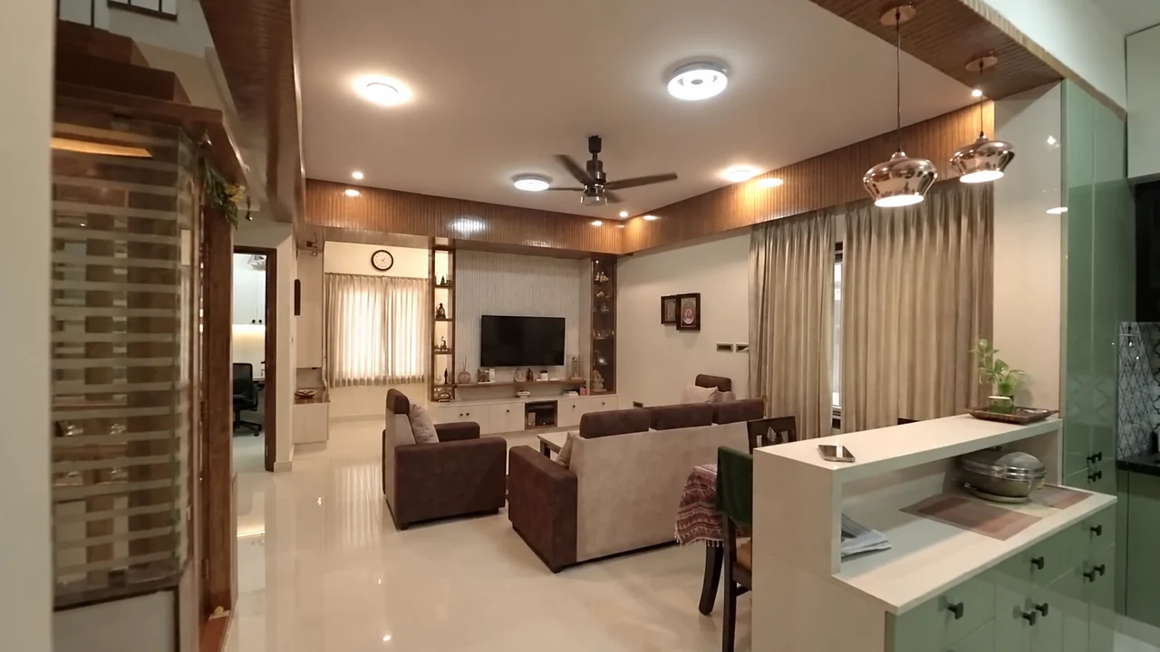 A connected living room with seating, television wall and dining counter